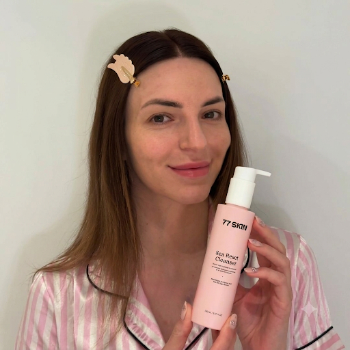 Woman holding Sea Reset Cleanser 